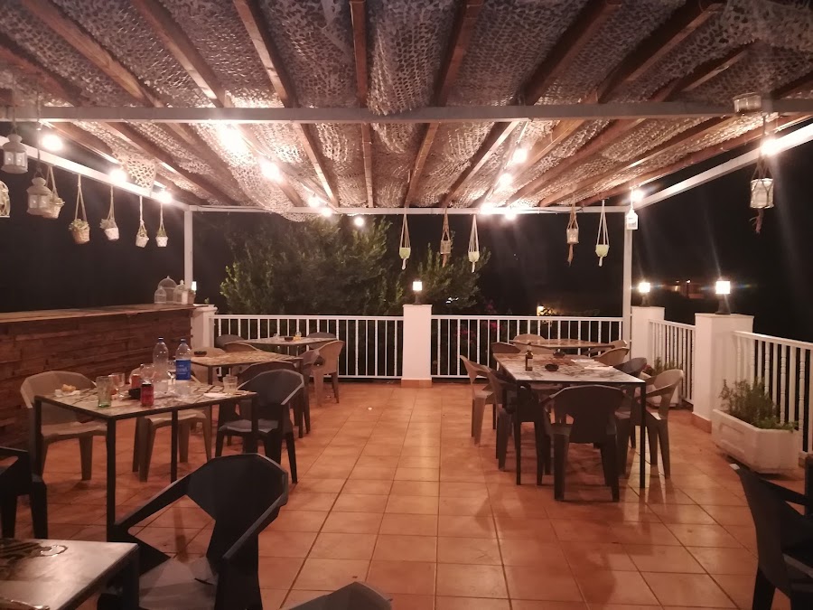 Terrace of La Tasca restaurant, lit up at night